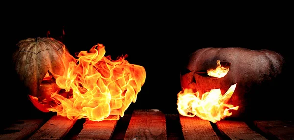 Two Very scary and dangerous Halloween pumpkins, with a menacing