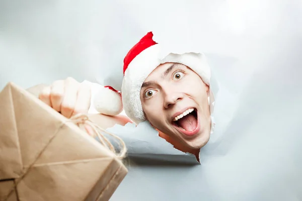 Christmas New Year concept, Stylish guy santa hat breaks through — Stock Photo, Image