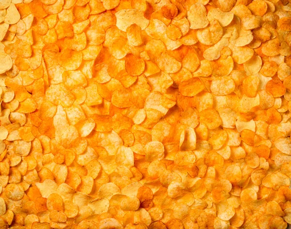 Chips textuur scherpe aardappel achtergrond van gouden ongezond voedsel p — Stockfoto