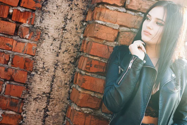 urban portrait Pretty girl in bra leather jacket with beautiful