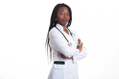 Female american african doctor, nurse woman wearing medical coat with stethoscope and tablet in poket. Happy excited for success medical worker posing on light background clipart