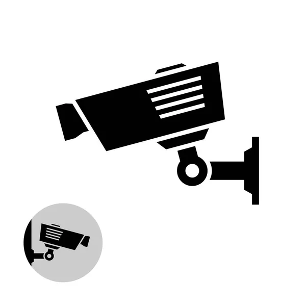Security camera simple black icon on the wall. — Stock Vector