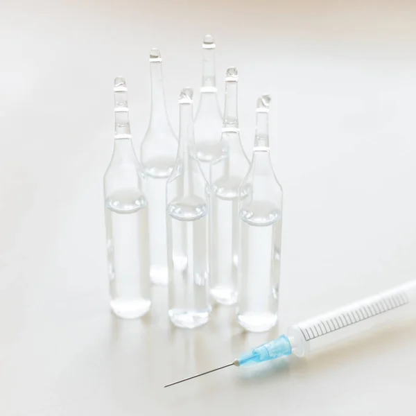 Injection. Vaccination against influenza, measle. Ampoules with syringe. Healthcare concept.