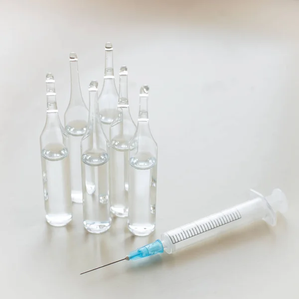 Injection. Vaccination against influenza, measle. Ampoules with syringe. Healthcare concept.