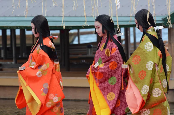 Japanese women in colorful traditional clothing take part in the Saigu Procession festival in Kyoto