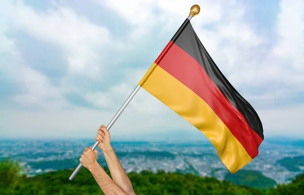 Young man's hands proudly waving the Germany national flag in the sky, part 3D rendering — Stock Photo, Image