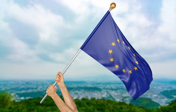 Young man's hands proudly waving the European Union flag in the sky, part 3D rendering