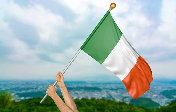 Τα χέρια του νεαρού που περήφανα κυματίζει η εθνική σημαία της Ιρλανδίας στον ουρανό, μέρος 3d rendering — Φωτογραφία Αρχείου