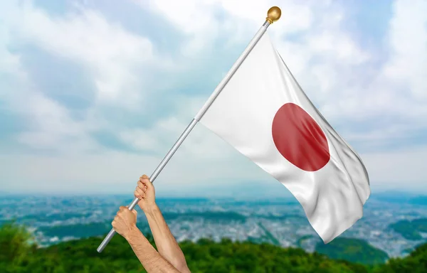Young man\'s hands proudly waving the Japan national flag in the sky, part 3D rendering