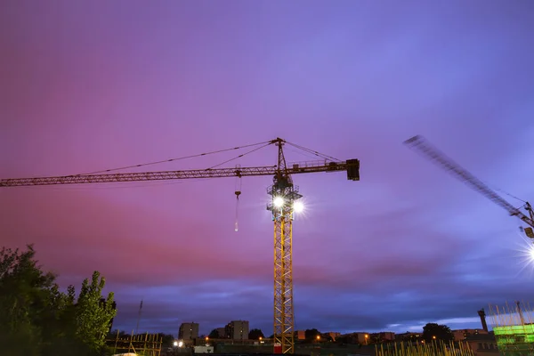 Tower cranes build residential buildings at nigh