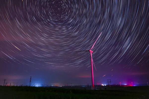 Wind turbines and star trails at night