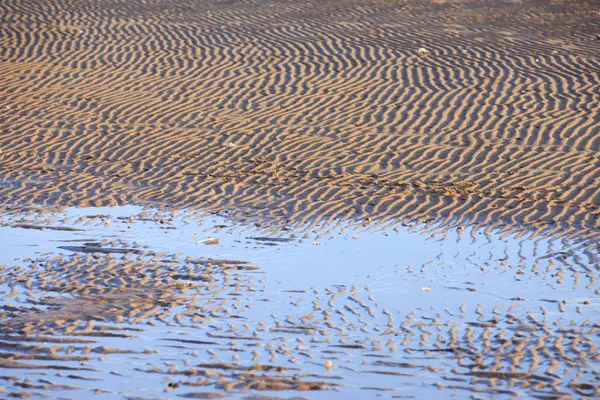 Текстура пляжного песка — стоковое фото