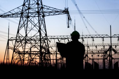 Electricity workers and pylon silhouette clipart