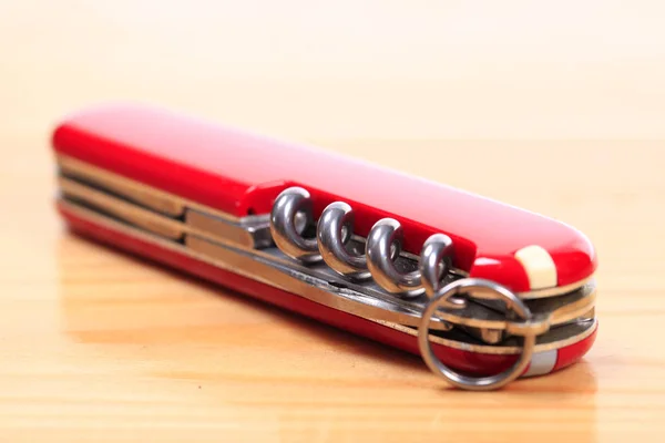 Swiss knife on a wooden background