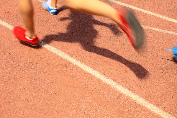 Athlètes qui courent sur le terrain de jeu de la piste — Photo