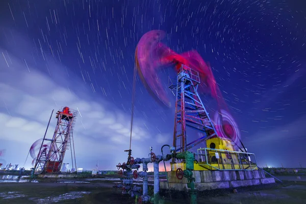 The oil pump and the trajectory of stars — Stock Photo, Image