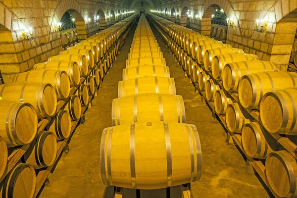 Wine barrels stacked in the cellar — Stock Photo, Image