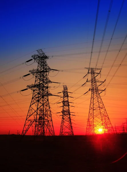 The silhouette of high voltage towers — Stock Photo, Image