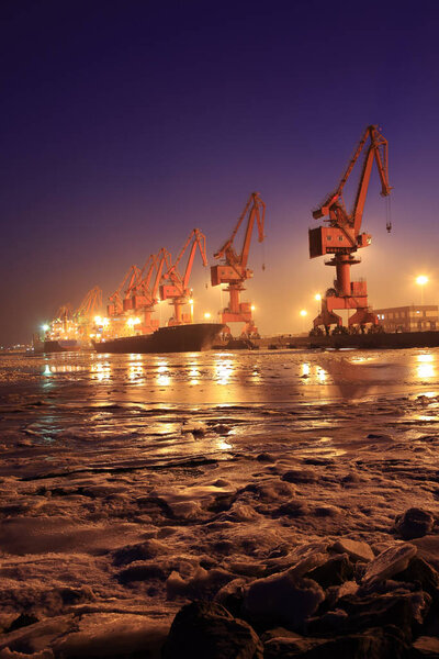 Cargo wharf crane at night