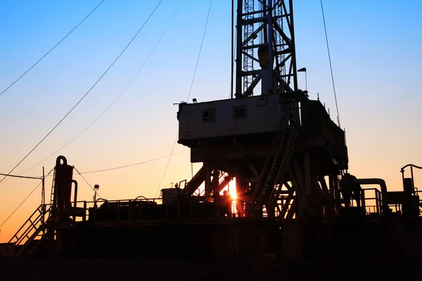 The silhouette of oilfield derrick