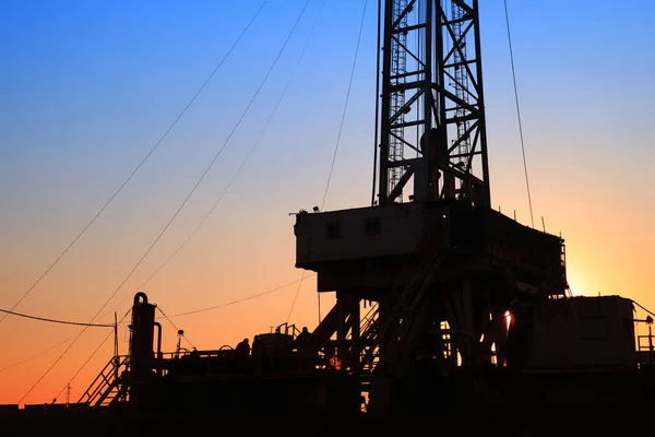 The silhouette of oilfield derrick