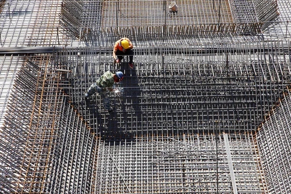 Nşaat Alanında Beton Döşeme Için Takviye Metal Iskeleti Yapan Işçiler — Stok fotoğraf