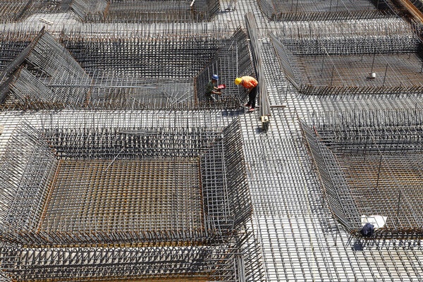 worker in the construction site making reinforcement metal framework for concrete pouring