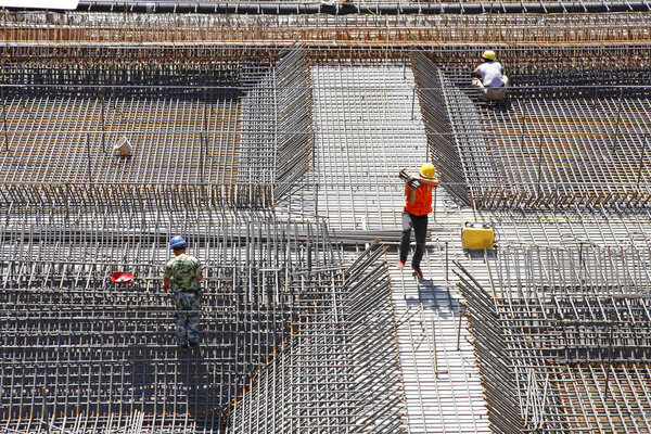 worker in the construction site making reinforcement metal framework for concrete pouring