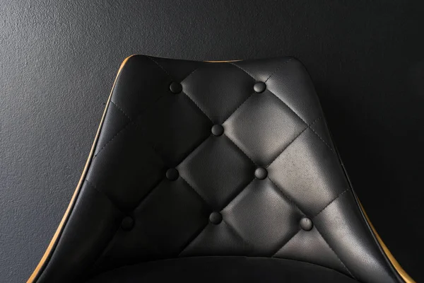 Black chair with black background closeup