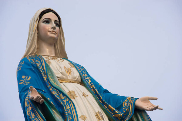 Virgin mary statue blue sky background