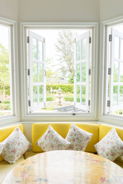 White window with yellow sofa vertical