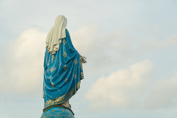 Our lady, The blessed Virgin Mary on blue sky background.