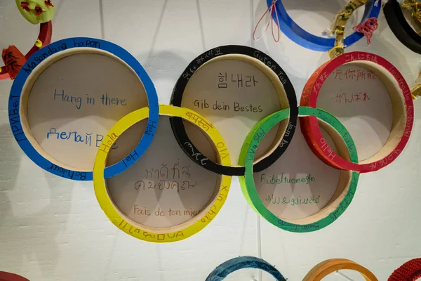 TOKYO, JAPAN - NOVEMBER 26, 2019: Fem olympiske ringe på det japanske olympiske museum med forskellige sprog i medlemslandet i Shinjuku-distriktet - Tokyo, Japan - Stock-foto