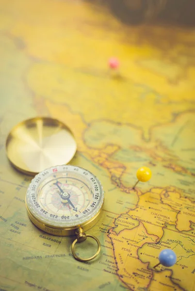 Compass on the world retro map. Selective focused. Vintage tone style.