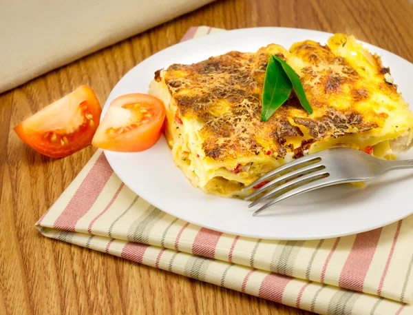 Lazanya çizgili peçeteye bir tabak 