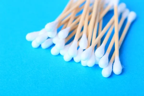 White cotton-tipped swabs, bud . Ear sticks close up on a blue background