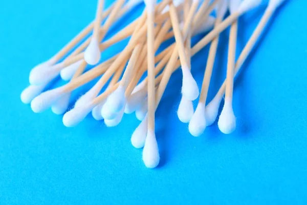 White cotton-tipped swabs, bud . Ear sticks close up on a blue background