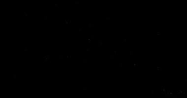 Siyah arkaplanda uçan toz parçacıkları