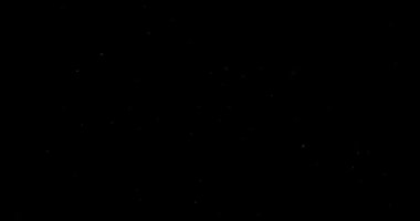 Siyah arkaplanda uçan toz parçacıkları