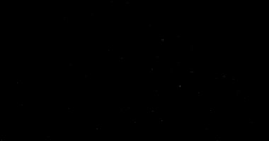 Siyah arkaplanda uçan toz parçacıkları