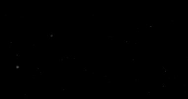 Siyah arkaplanda uçan toz parçacıkları