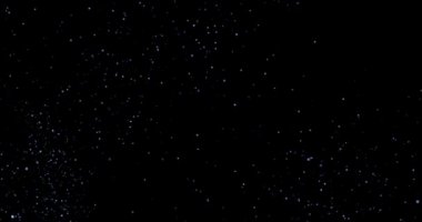 Siyah arkaplan videosundaki soyut uçan toz parçacıkları