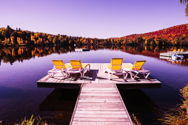 view of a boat dock the Lac-Superieur, misty morning with fog, in Laurentides, Mont-tremblant, Quebec, Canada