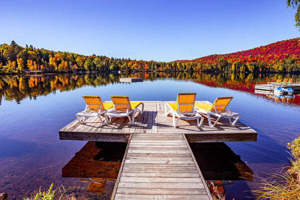 view of a boat dock the Lac-Superieur, misty morning with fog, in Laurentides, Mont-tremblant, Quebec, Canada