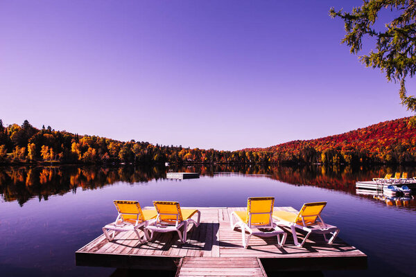 view of a boat dock the Lac-Superieur, misty morning with fog, in Laurentides, Mont-tremblant, Quebec, Canada