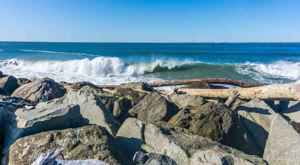 Waves roll onto the rock breakwater in Westport, Washington.