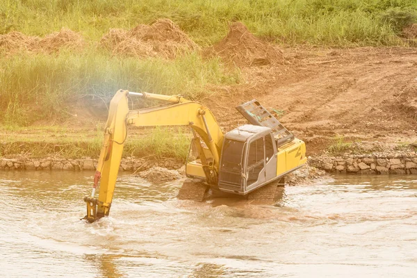 Balde de pá na margem do rio, cargas de elevação, máquinas de construção — Fotografia de Stock