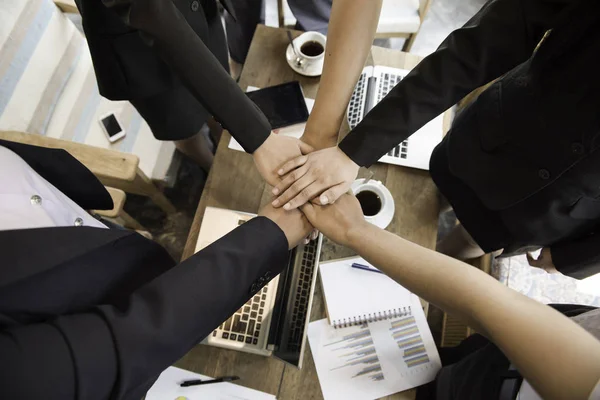 Group of business people joining hands. (team)