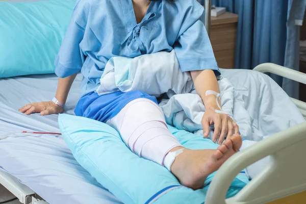 Asian woman patient with knee brace with walking stick and knee braces  support in hospital ward after ligament surgery. Stock Photo by ©mkitina4  344381052