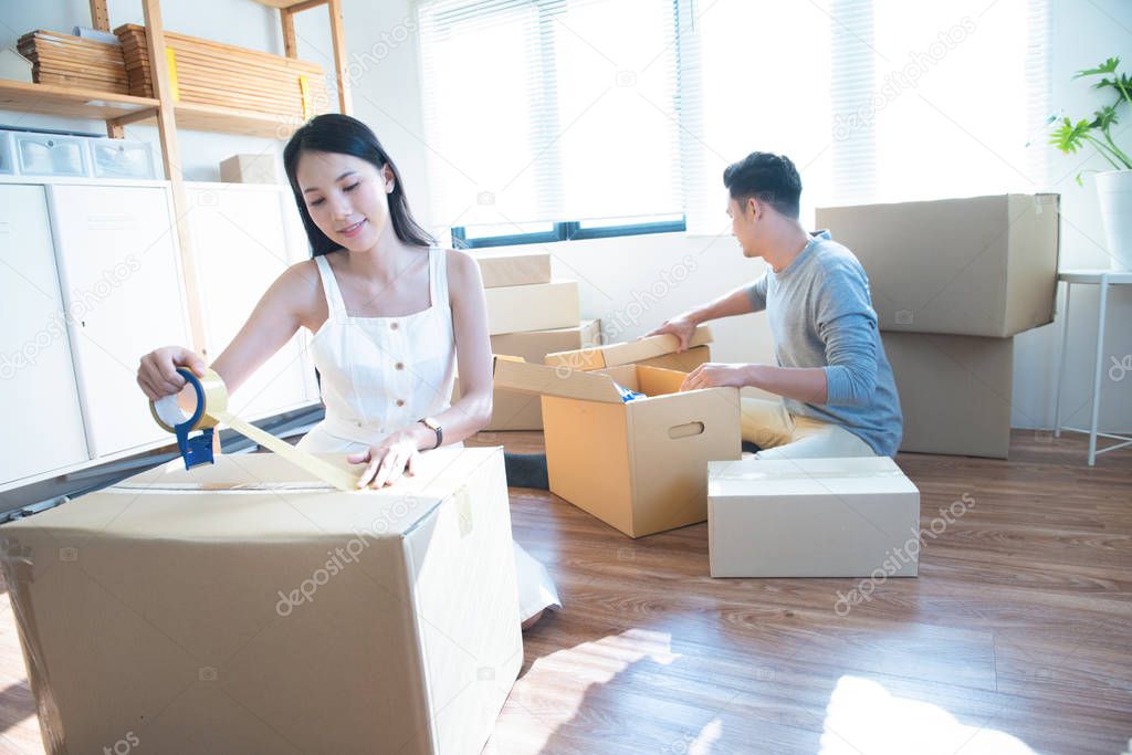 startup small business owner at workplace. freelance asian man and asian woman seller check product order, packing goods for delivery to customer. Online selling, e-commerce, shipping concept.